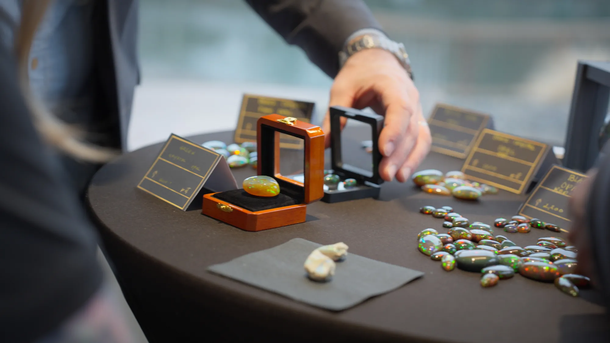 Setting up a parcel of black opals at an international gem show
